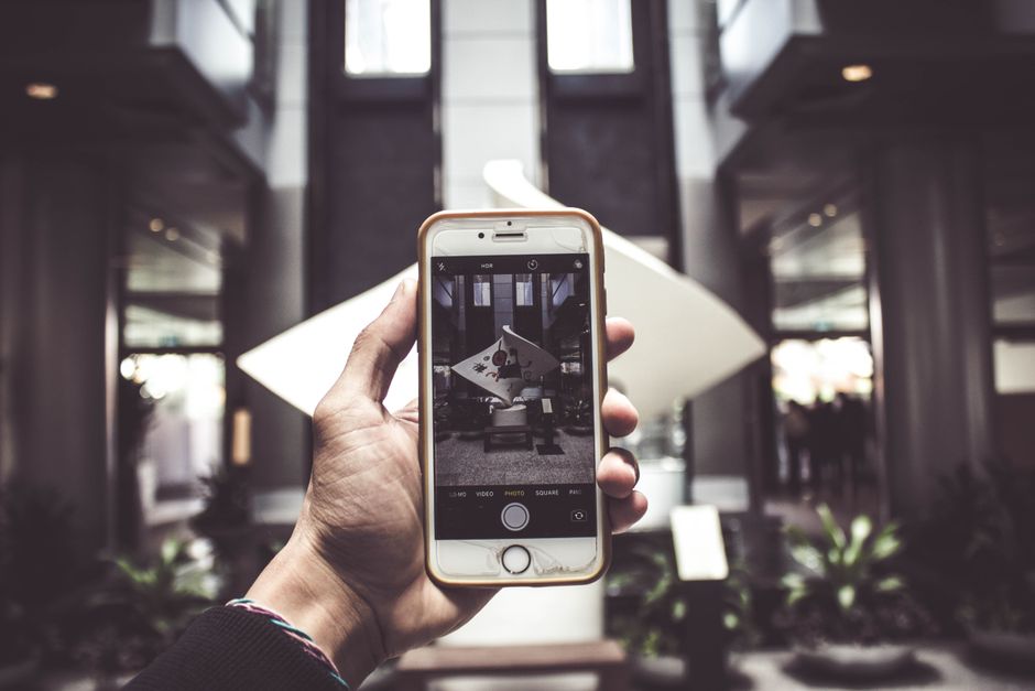Person holding smartphone Singapore skyline