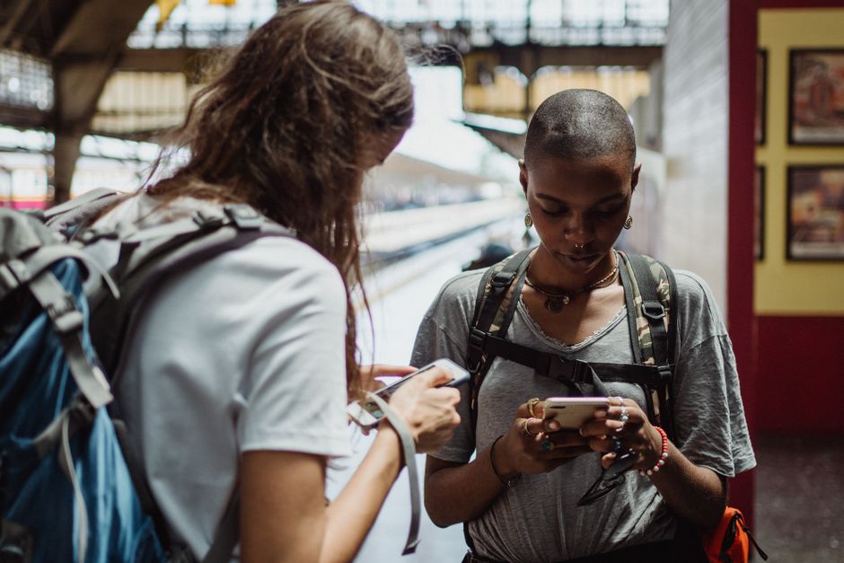 Traveler using phone in European city