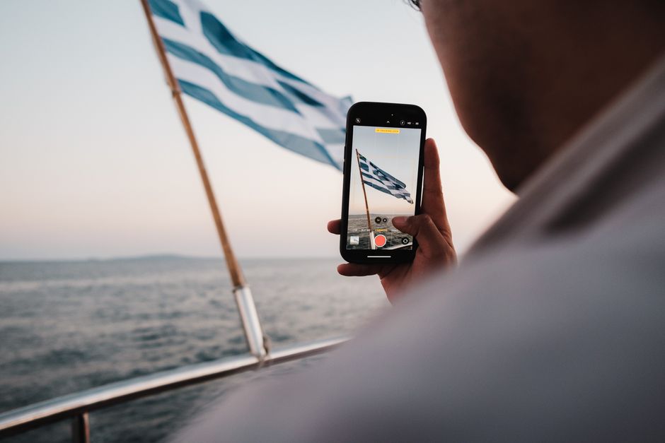 Person holding phone with US flag background