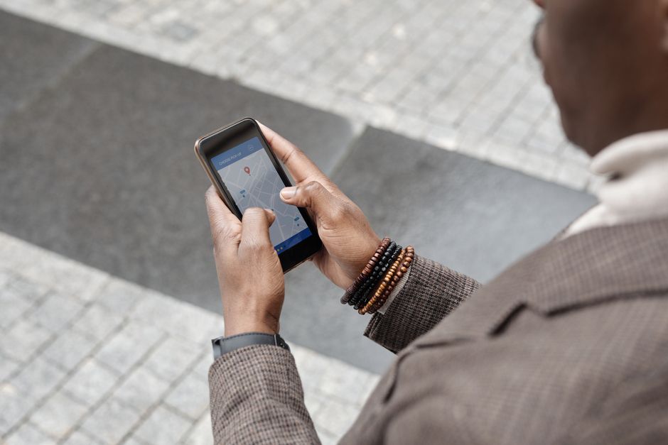 hand holding phone with travel map background