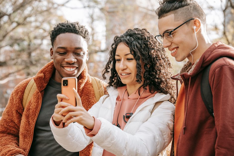 Group of friends looking at smartphone