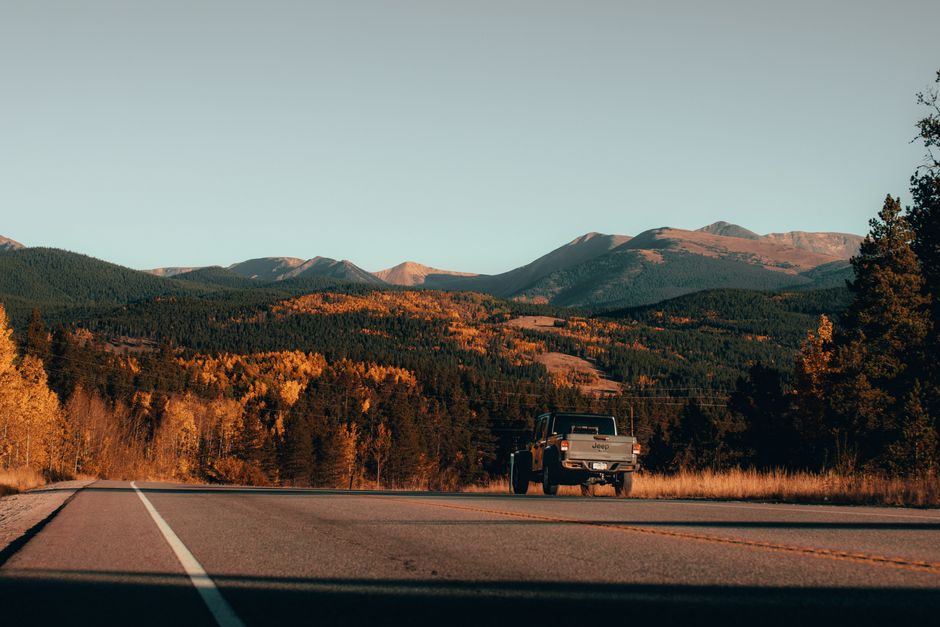 White pickup truck on mountain road