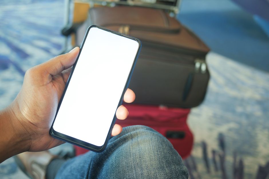 Person holding smartphone airport