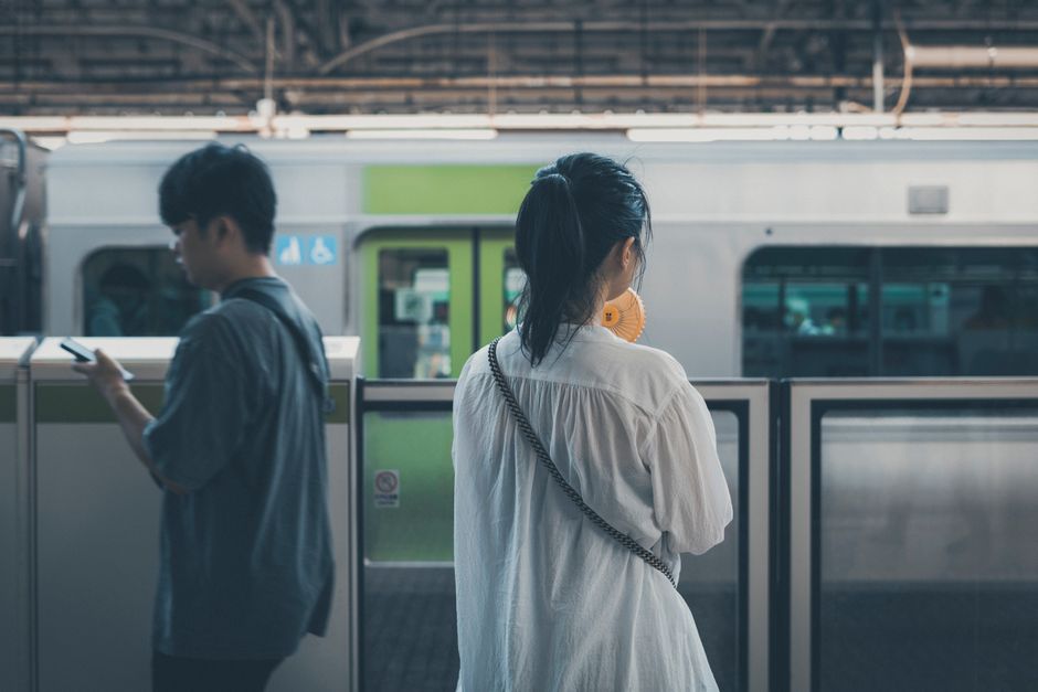 traveler checking smartphone map at Tokyo station platform