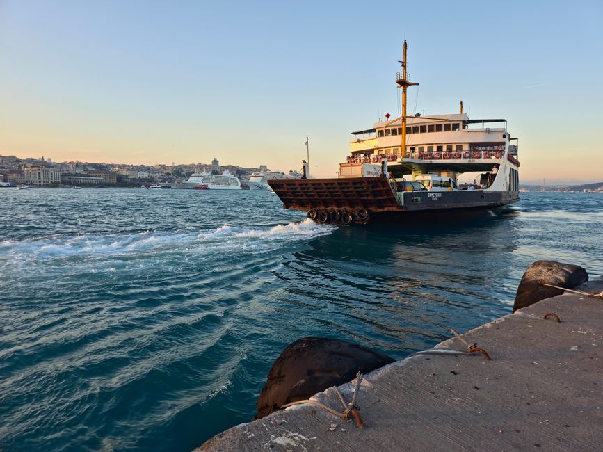 Ferry pier at sunset with boats