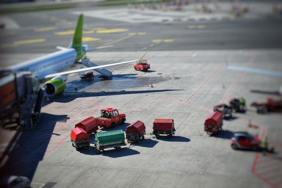 Car rental pickup at airport with family loading luggage