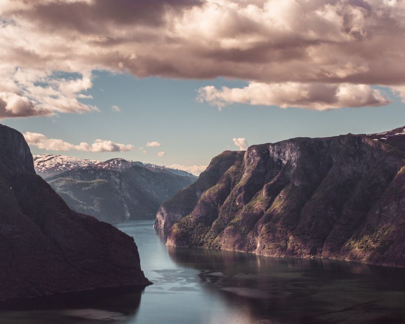 Scenic Norwegian fjord with smartphone showing map