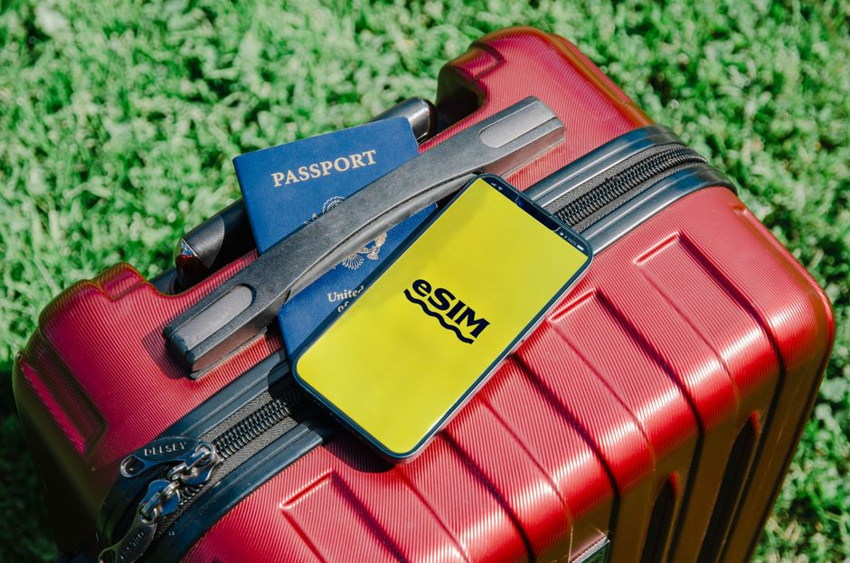 Traveler packing suitcase with passport and phone